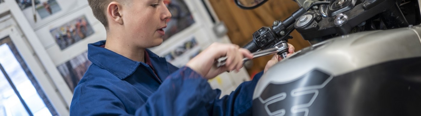 Student working on a motorbike